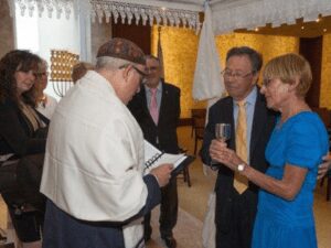 Rabbi reading blessing to couple indoors