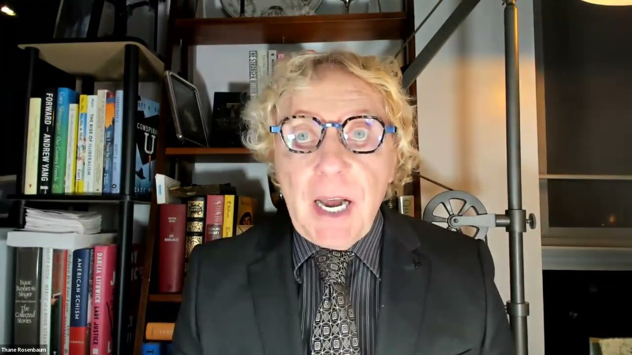 Person wearing glasses and suit on video