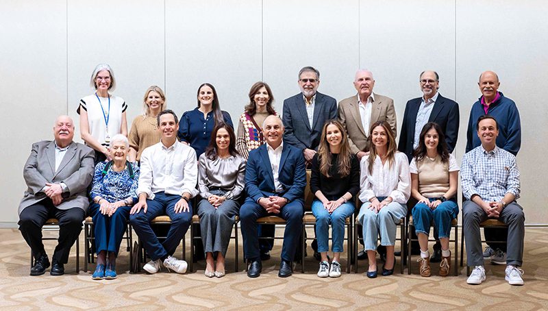 Group portrait of people in conference room