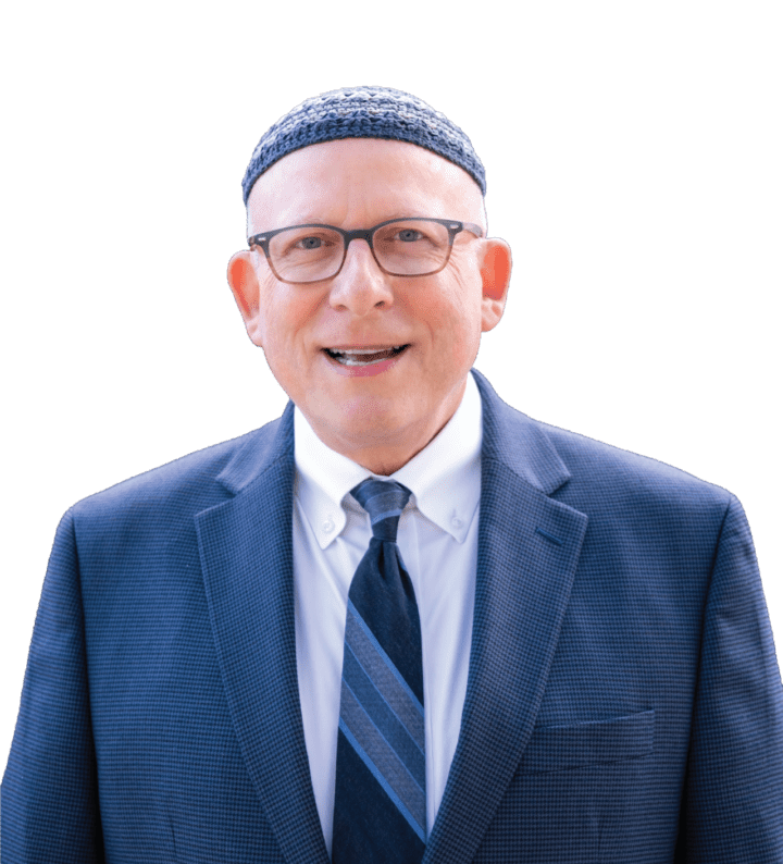 Smiling man in suit, glasses, and tie